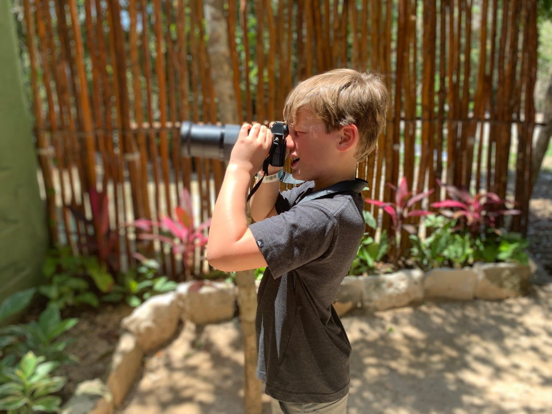 Isaac as a boy, watching through binoculars at a wildlife park